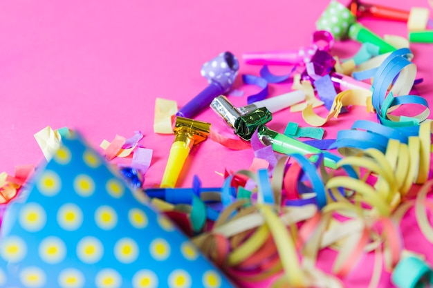 Close-up party horns on confetti