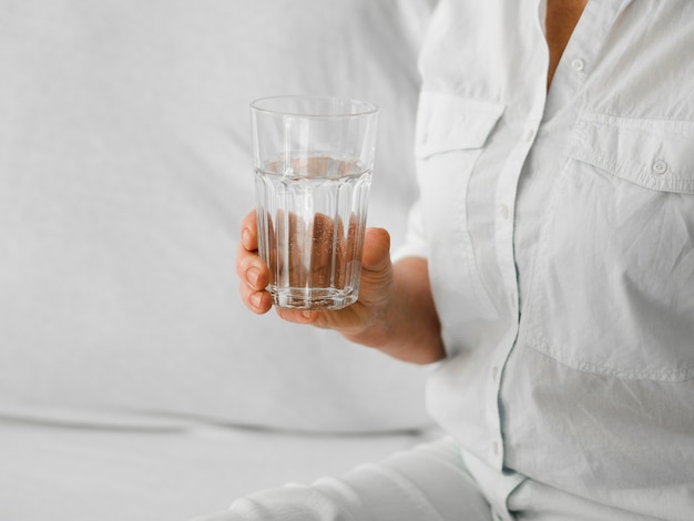 Close-up patient holding glass