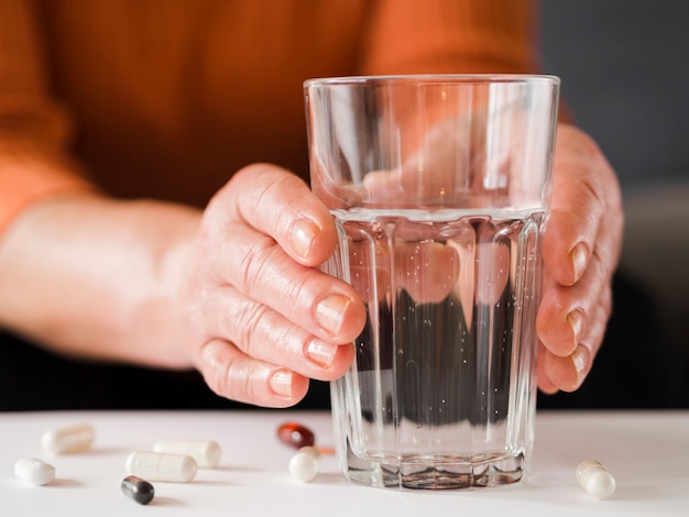 Close-up patient holding glass