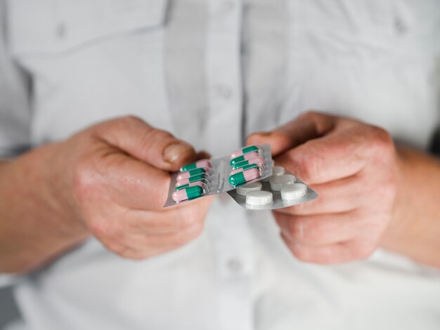 Close-up patient holding medication