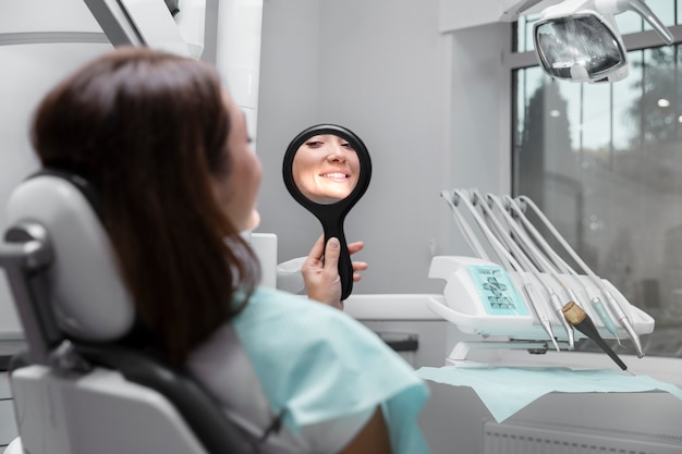 Free photo close up patient looking in the mirror