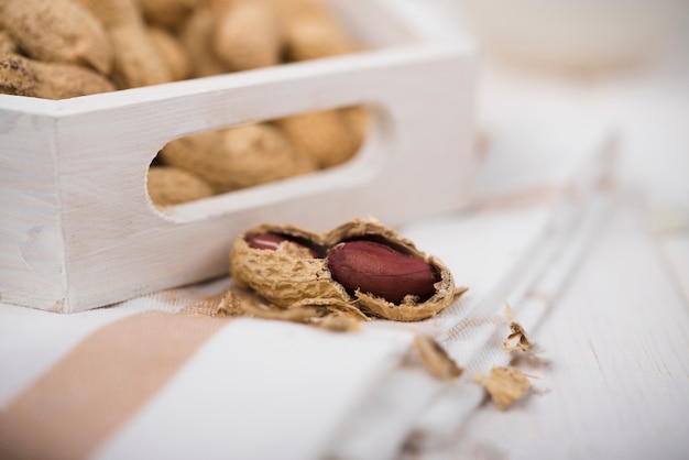 Free photo close-up peanuts on wooden table