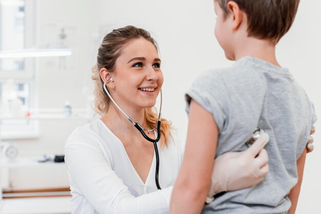 Close-up pediatrician checking kid