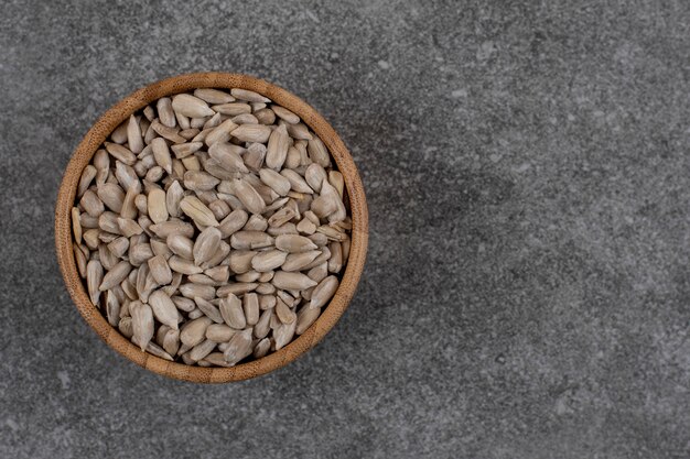 Close up of peeled sunflower seeds over grey surface