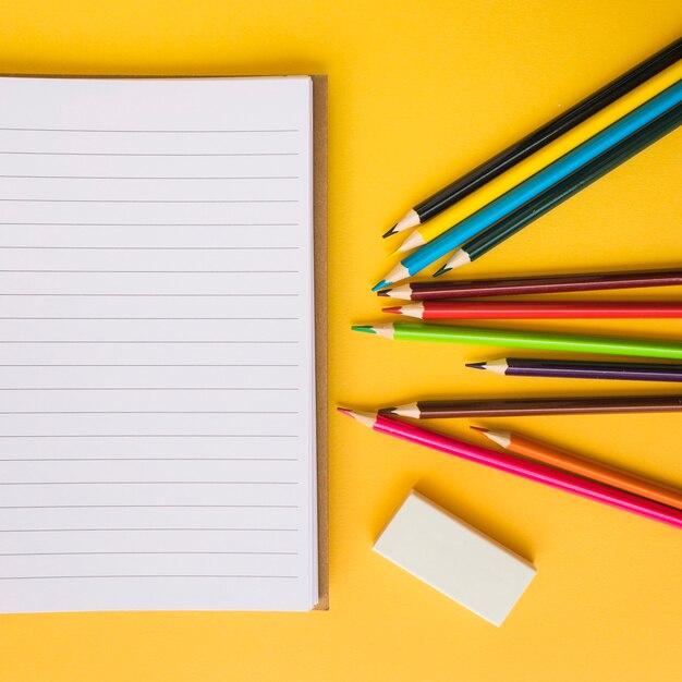 Close-up pencils and rubber near notepad