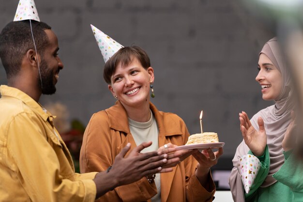 Close up people celebrating with cake