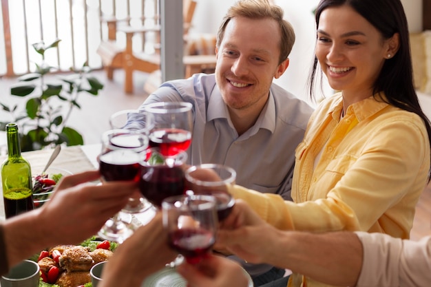 Close up people celebrating with wine