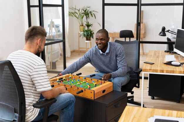 Close up on people having fun while playing table soccer