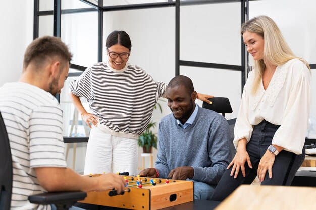 Close up on people having fun while playing table soccer