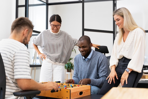 Close up on people having fun while playing table soccer