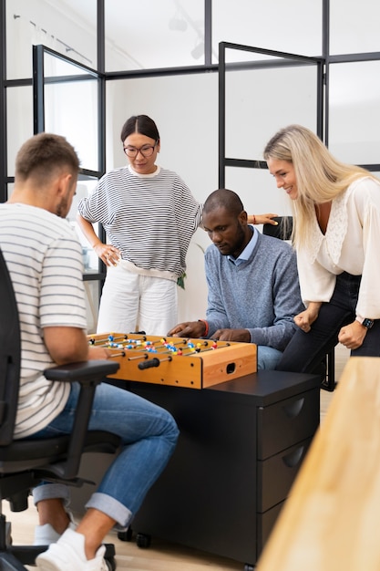 Close up on people having fun while playing table soccer