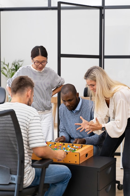 Free photo close up on people having fun while playing table soccer