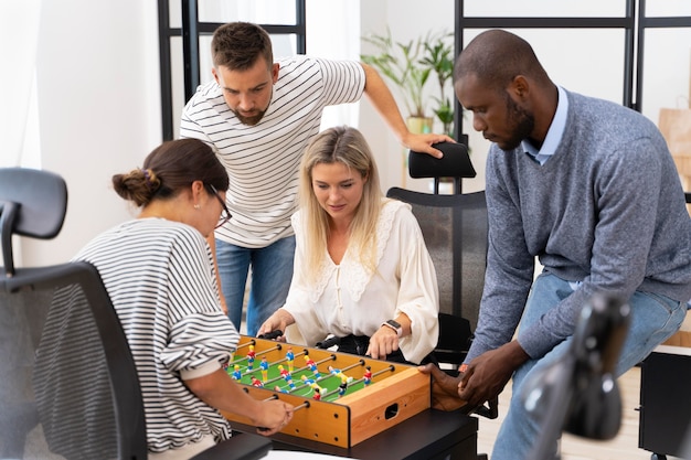 Close up on people having fun while playing table soccer