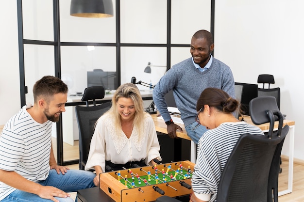 Close up on people having fun while playing table soccer