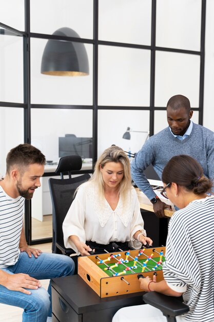 Close up on people having fun while playing table soccer