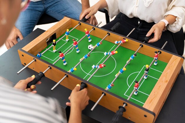 Close up on people having fun while playing table soccer