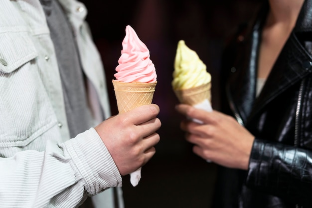 Free photo close up people holding ice cream