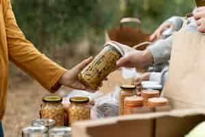 Free photo close up people holding jar