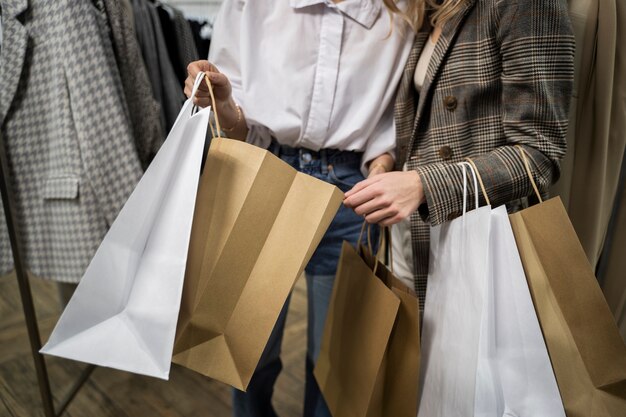 close up people holding shopping bags