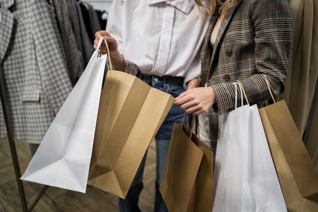 Close up people holding shopping bags