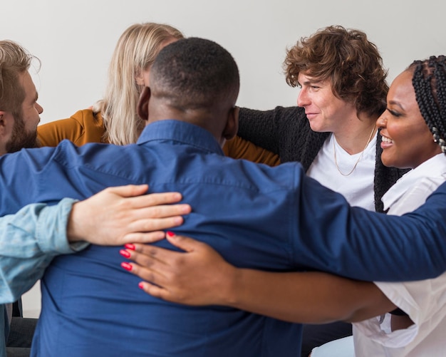 Close-up people hugging indoors