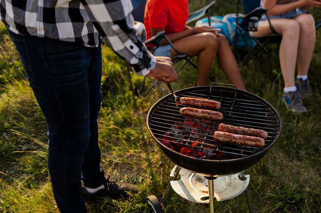 Close up people making barbecue