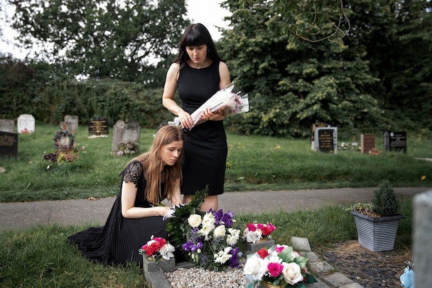 Close up on people visiting the grave of loved one