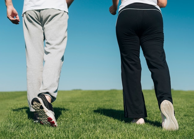 Close-up people walking on the grass