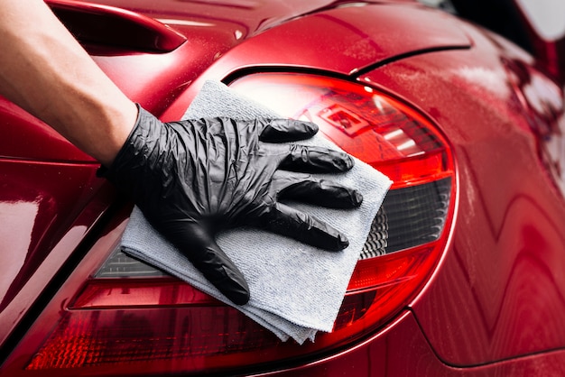 Close up of person cleaning car exterior