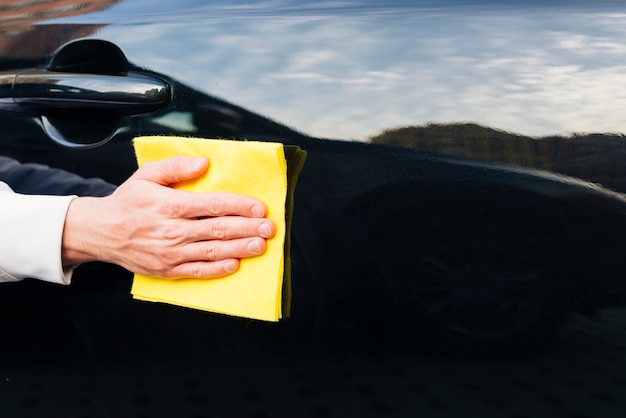 Close up of person cleaning car exterior