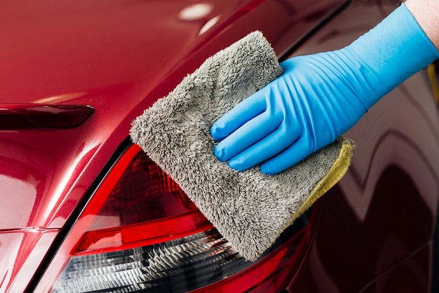 Close up of person cleaning car exterior