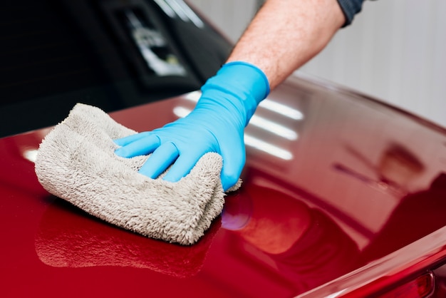 Close up of person cleaning car exterior