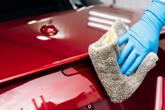 Close up of person cleaning car exterior