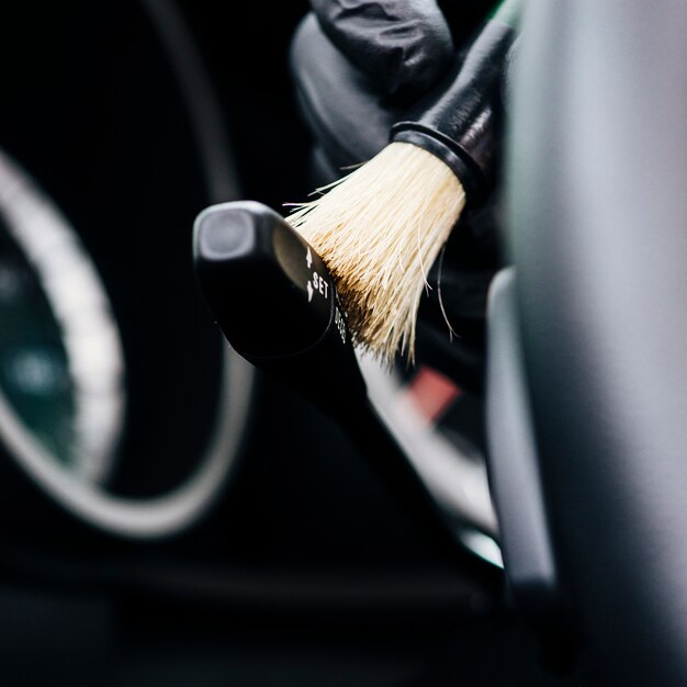 Close up of person cleaning car interior