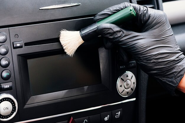 Close up of person cleaning car interior