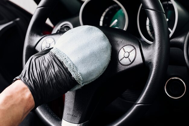 Close up of person cleaning car interior