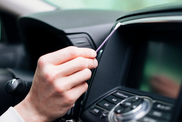 Close up of person cleaning car interior