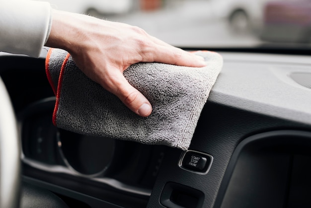 Close up of person cleaning car interior