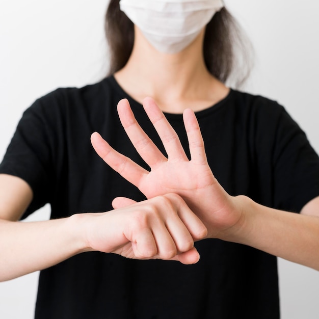 Close-up person communicating through sign language