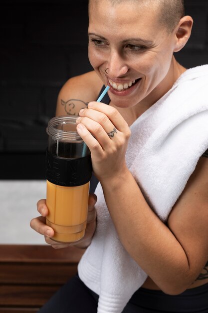 Free photo close up on person drinking juice of food complements