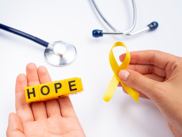 Close-up person holding awareness ribbon 