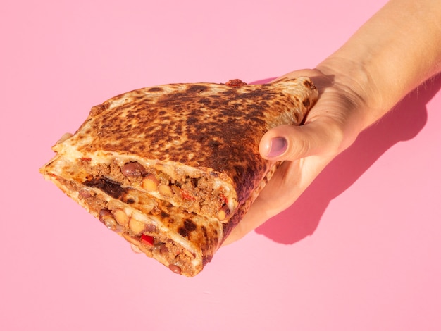 Close-up person holding delicious mexican food