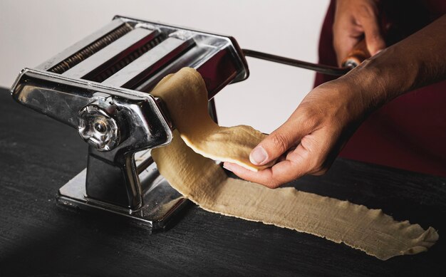 Close-up person holding dough for pasta