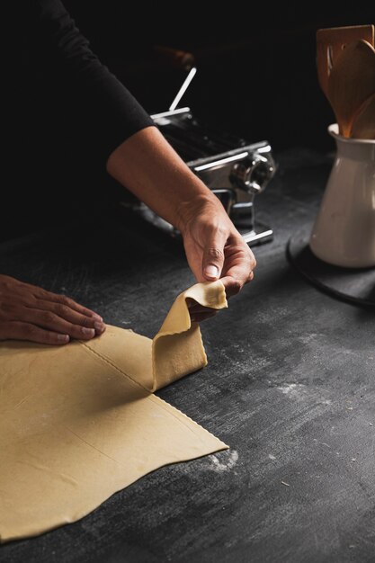 Close-up person holding dough 