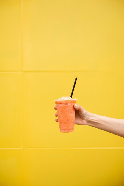 Close-up person holding glass of juice