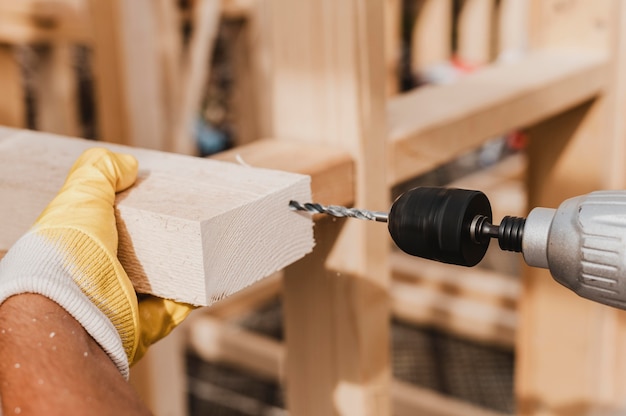 Free photo close-up person holding a hammer drill