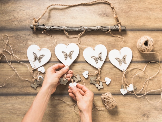 Free photo close-up of a person holding heart windchimes