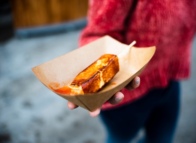 Free photo close-up person holding junk food