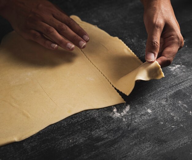 Close-up person holding pastry dough