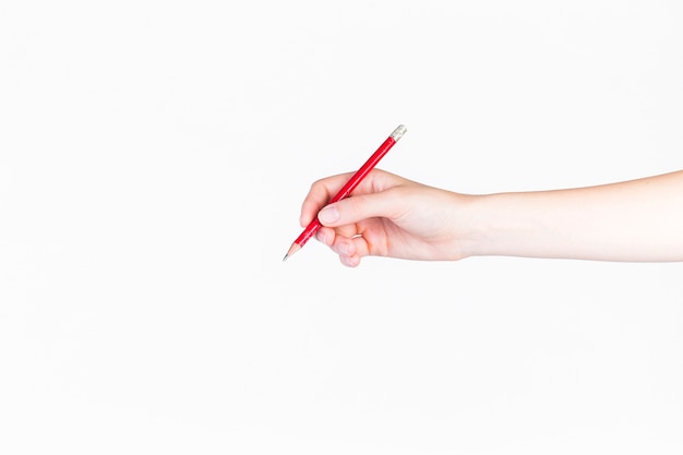 Close-up of a person holding pencil on white background